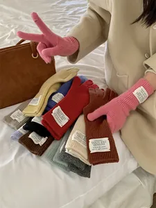 Assortment of multi-colored warm knitted touchscreen gloves for women in winter season