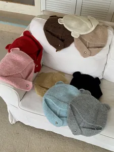 Variety of colorful knitted bear ear hats for winter warmth and cute fashion style