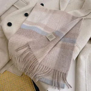 Detailed macro view of a 100% Australian wool plaid scarf with refined fringe edges