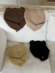 Soft knitted bear ear beanies with heart-shaped buttons in four warm neutral colors