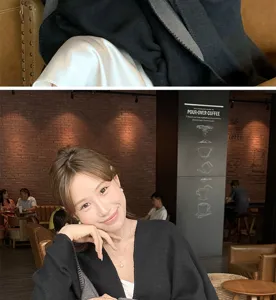 Elegant woman wearing a black and grey knit shawl cloak in a cozy cafe atmosphere