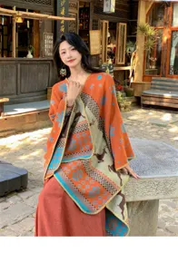 Detail of Bohemian style knitted poncho shawl featuring ethnic elk and snowflake patterns