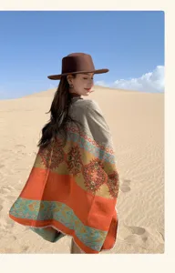 Rear view of a bohemian knit poncho with ethnic geometric patterns in a desert setting