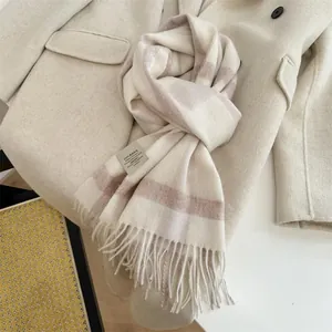 Detailed view of premium 100% Australian wool plaid scarf with elegant tassels in beige