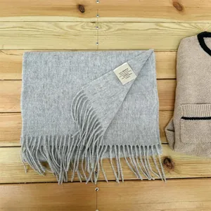 Close-up of 100% Australian wool scarf with fringed edges and material tag