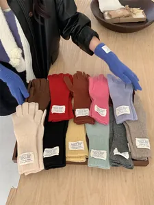 Detail view of multi-colored knitted gloves in various soft autumn shades