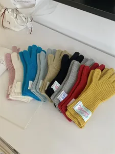 Assorted multi-color knitted wool gloves featuring vintage Grove Woolwear cloth labels