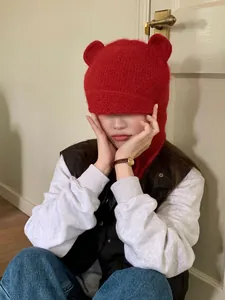 Adorable red knitted winter beanie with plush bear ears and warm ear protection detail