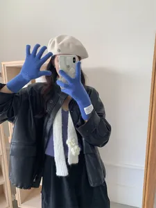 Stylish Klein blue long knit gloves for women shown in a trendy autumn lifestyle outfit