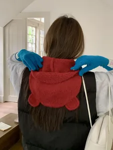 Detailed back view of a cute red knitted bear ear hood, perfect for winter warmth