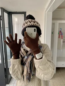 Brown knit winter gloves for women with touch screen compatibility and label detail