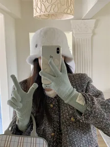 Close-up of women's knitted gloves with convenient touchscreen finger holes.