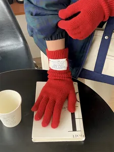 Red knitted winter gloves for women with touch screen fingers and stylish patch