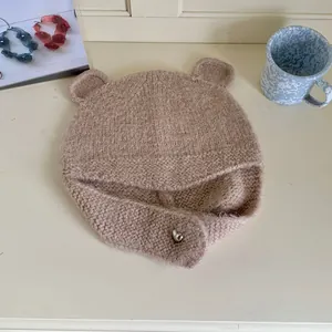 Detailed view of the bear ear knit beanie showing soft wool texture and ear flaps