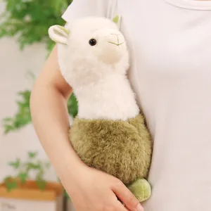Adorable white and green llama plush toy being held for size perspective and texture.