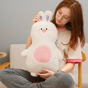 Cute white cartoon rabbit plush toy pillow with pink belly held by a model in home setting