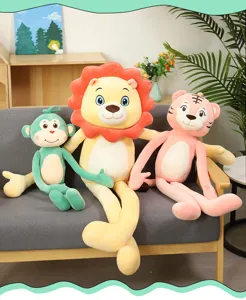 Soft long-legged monkey lion and tiger plush toys displayed on a cozy grey home sofa