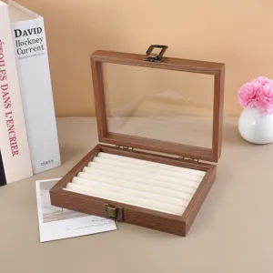 Joyero de madera de nogal con tapa de cristal y rollos de almacenamiento blancos