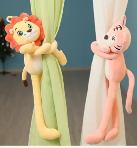 Cute long-legged lion and tiger plush dolls used as decorative curtain tie-backs in a room