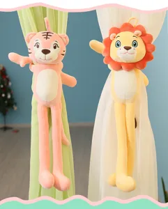 Detailed view of cute long-legged lion and tiger plush dolls used as curtain tiebacks