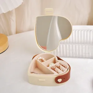 Beige heart-shaped portable jewelry storage box for travel with mirror and leather strap