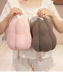 Soft sherpa pumpkin plush pillows in pink and brown showcasing cozy texture and size