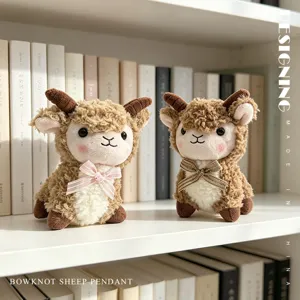 Pair of adorable plush sheep pendants with stylish bowknots displayed on a shelf