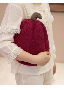 Detail view of wine red pumpkin plush pillow made of soft sherpa fabric for home decor.
