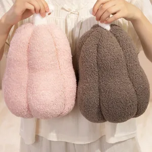 Cozy pumpkin-shaped plush pillows in pink and brown sherpa fleece for home decor
