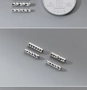 Close-up detail of faceted 10mm S925 sterling silver tube beads for DIY jewelry making