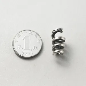 Retro S925 sterling silver snake spiral spacer bead shown with coin for scale in DIY jewelry making