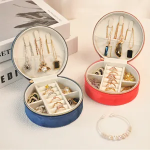 Close-up detail of the oval velvet jewelry box interior with dividers for rings and necklaces