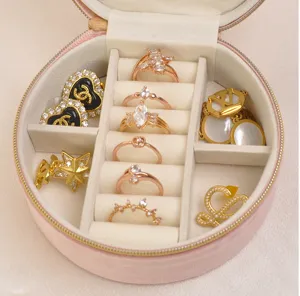 Detailed view of the soft pink velvet jewelry box interior with organized slots