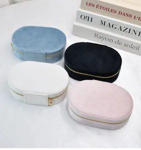 Macro view of four colorful oval velvet jewelry boxes with elegant gold zippers
