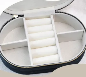 Close-up of the organized internal compartments in an oval velvet jewelry box