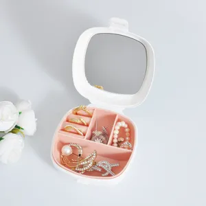 Boîte à bijoux blanche portable avec miroir et compartiments roses pour les bijoux