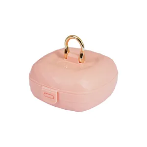 Boîte à bijoux portable en silicone rose avec design à facettes et anneau