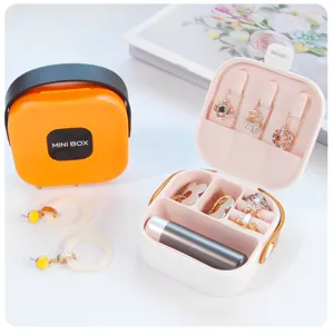 Detailed view of portable jewelry storage box with compartments for rings and necklaces