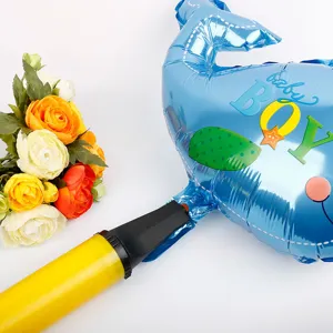 Close-up showing manual yellow pump inflating a blue baby boy dolphin foil balloon