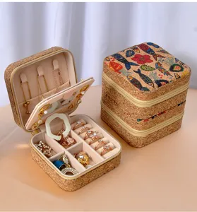 Detailed view of portable cork jewelry box with internal mirror and floral print design