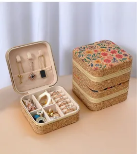 Close-up detail of floral cork jewelry box showing interior ring slots and necklace hooks
