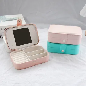 Elegant portable PU leather jewelry box with built-in mirror and ring storage slots