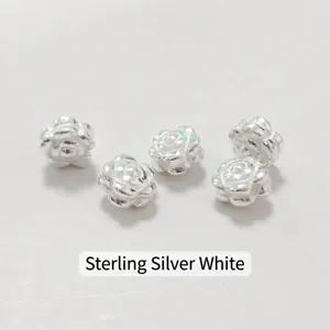 Detailed macro view of silver rose flower spacer beads for DIY jewelry making accessories.