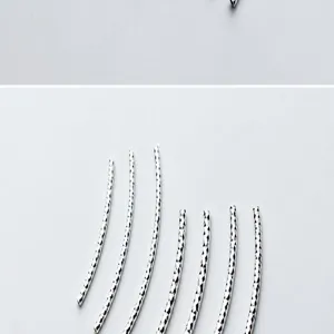 Detailed macro shot of S925 silver diamond-cut curved tubes for DIY jewelry crafts.