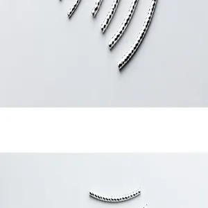 Detailed view of S925 silver curved tubes with a diamond-cut texture for DIY jewelry crafts