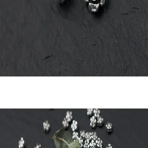 Close-up macro view of vintage S925 silver rose-shaped flower spacer beads for DIY jewelry