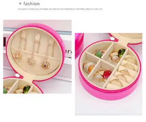 Detailed view of pink round jewelry box with compartments for rings and necklaces.