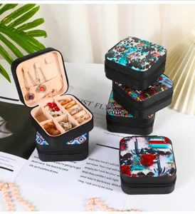 Detailed view of portable jewelry organizer box with western patterns and velvet interior