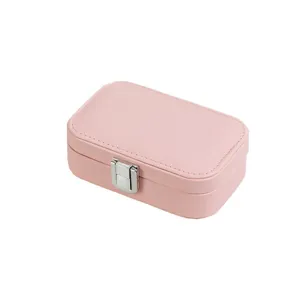 Compact pink portable jewelry storage box with silver metal clasp and faux leather finish
