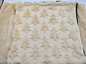 Detail view of cream plush Christmas pillowcase with quilted tree pattern texture